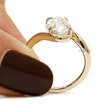Vintage style engagement ring with moval lab grown diamond, antique cut, and curved bypass gold band