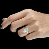 Antique inspired moval moissanite ring with twisted bypass setting in yellow gold
