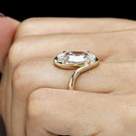 Bypass solitaire ring featuring antique moval lab grown diamond and handcrafted swirl band