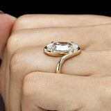 Bypass solitaire ring featuring antique moval lab grown diamond and handcrafted swirl band