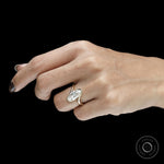 Antique inspired moval moissanite ring with twisted bypass setting in yellow gold