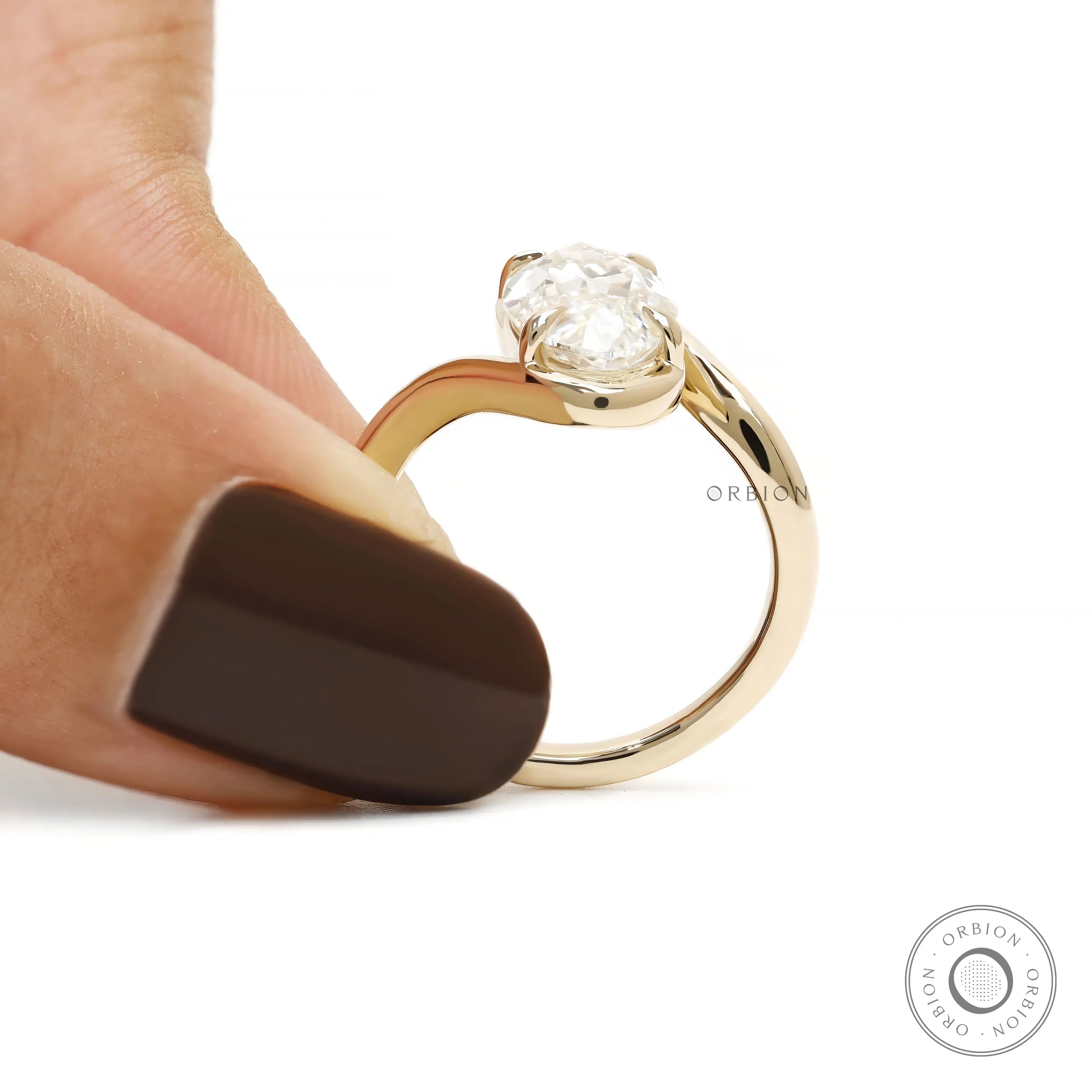 Vintage style engagement ring with moval lab grown diamond, antique cut, and curved bypass gold band