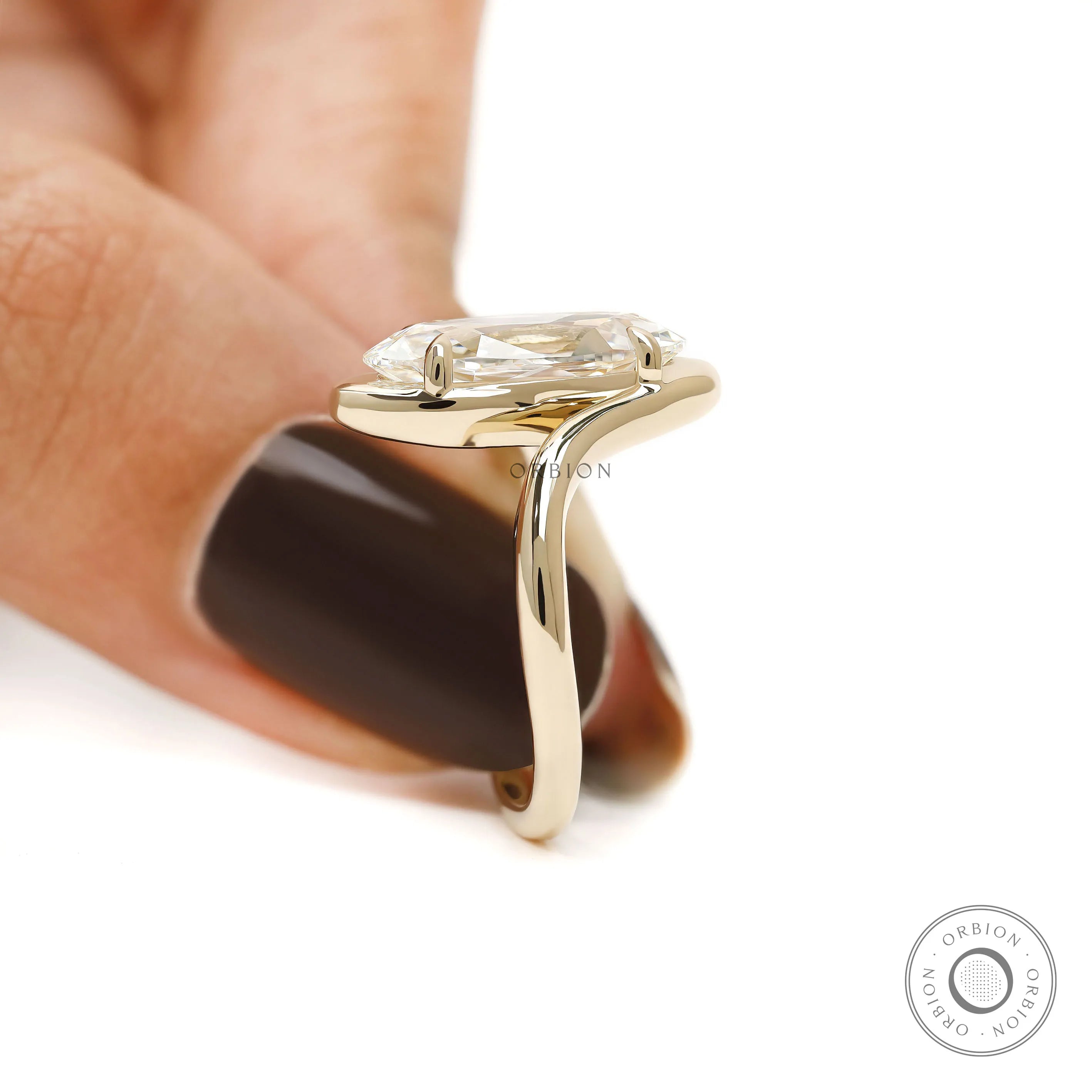 Unique bypass engagement ring featuring old mine cut lab diamond in moval shape with 14k yellow gold swirl band