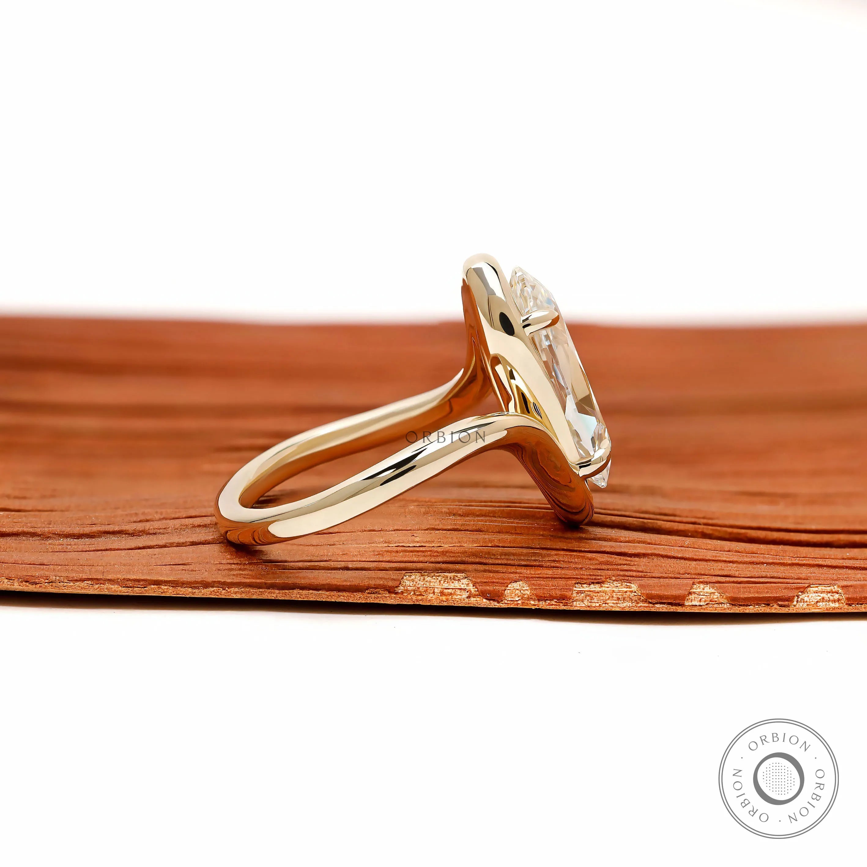 Elegant moval shaped lab grown diamond engagement ring with swirl band and vintage inspired yellow gold setting