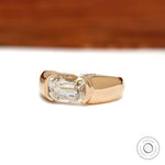 Mens moissanite wedding ring featuring an elongated cushion cut stone in an east west 14k yellow gold setting