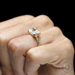 Modern fine jewelry ring with radiant cut moissanite, half bezel floating design and 14k yellow gold band