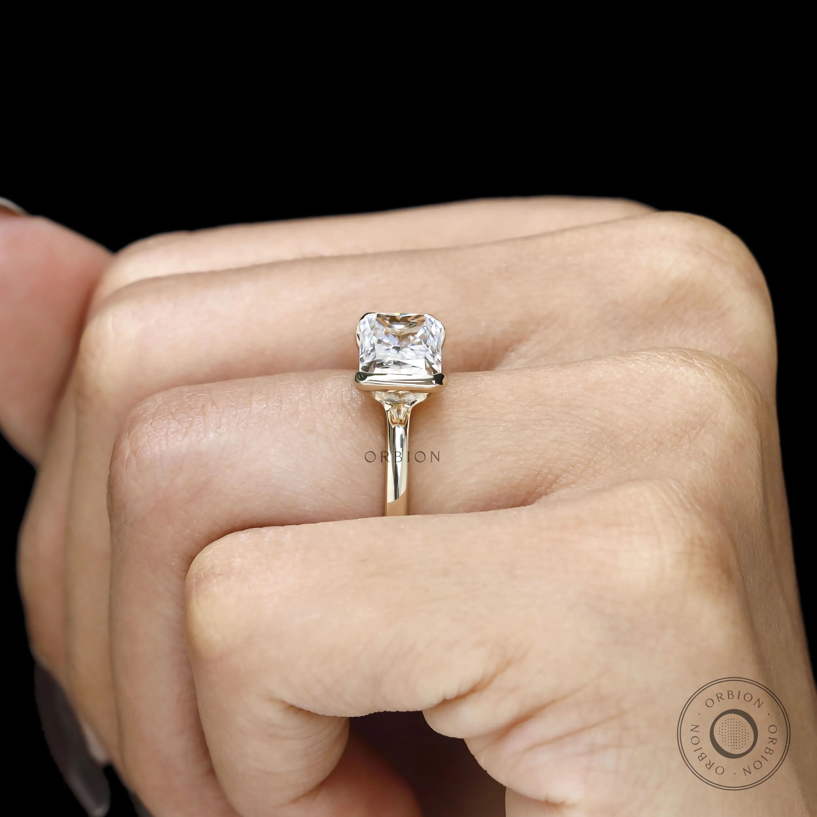 Elegant east west radiant cut lab diamond engagement ring with sleek bezel setting and minimalist style