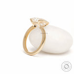Minimalist radiant cut moissanite solitaire ring with east west orientation and contemporary half bezel design