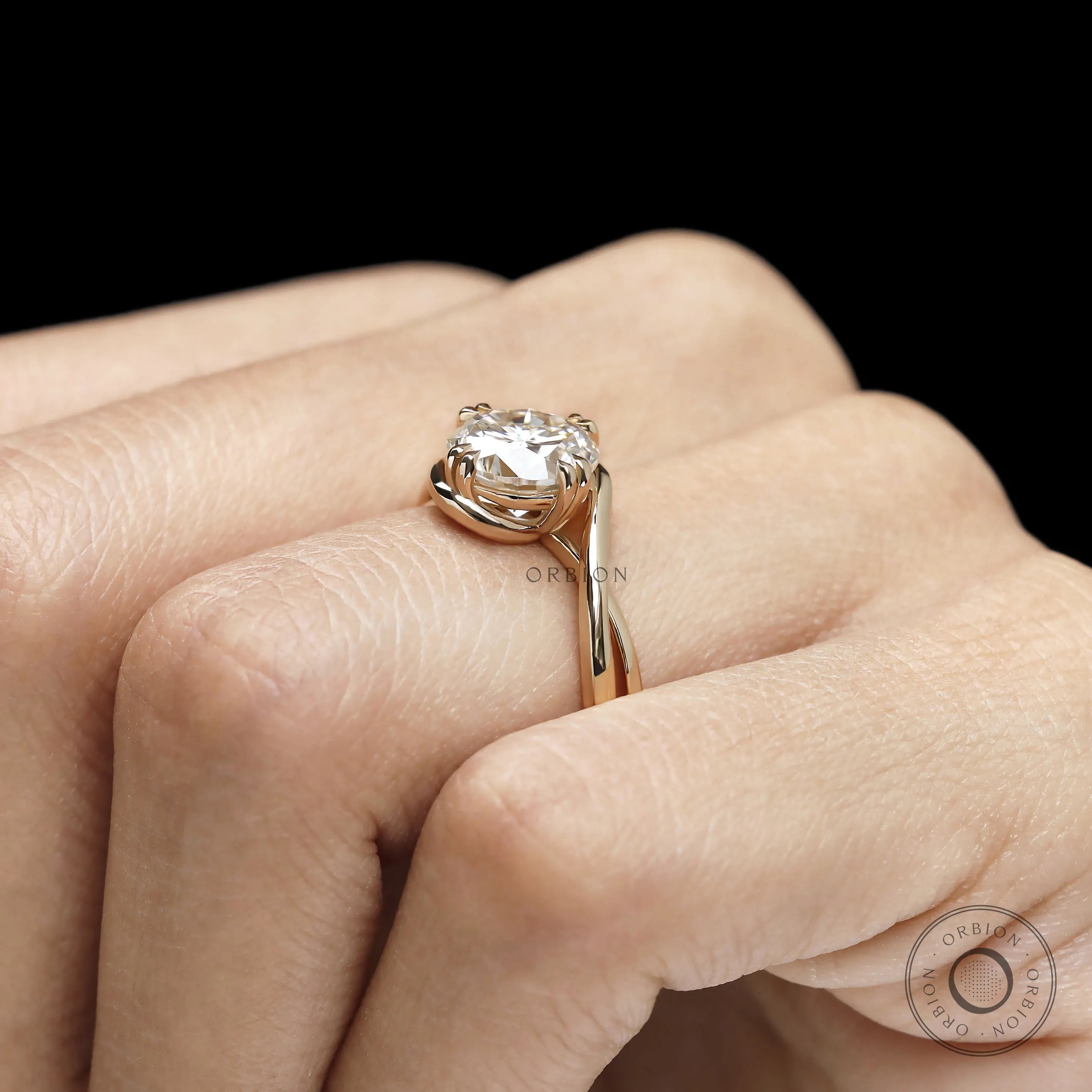 Lab diamond or moissanite crossover engagement ring featuring round cut stone and artistic swirl solitaire design