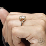 14k yellow gold alternative engagement ring with round moissanite, twisted bypass band and claw prong setting