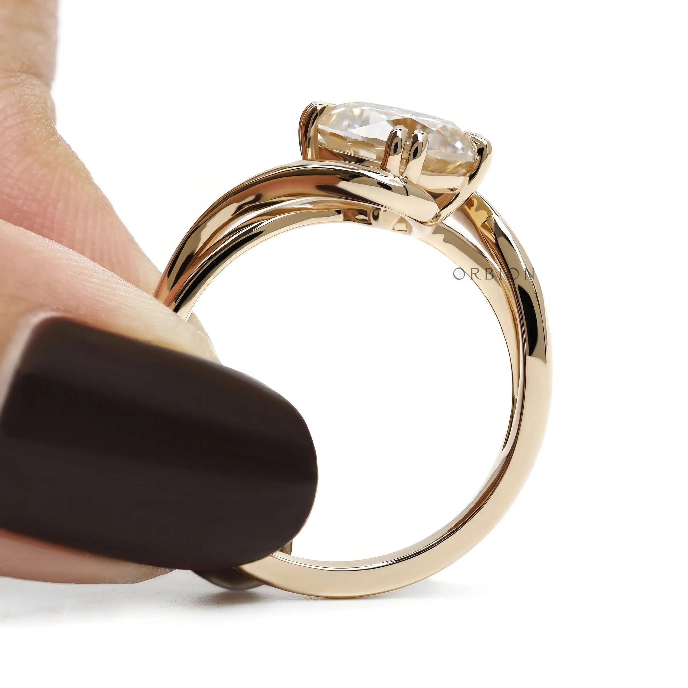 Alternative anniversary ring featuring round cut moissanite in 14k yellow gold compass setting