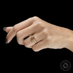 Unique victorian engagement ring featuring pink diamond center stone and detailed engraved leaf band