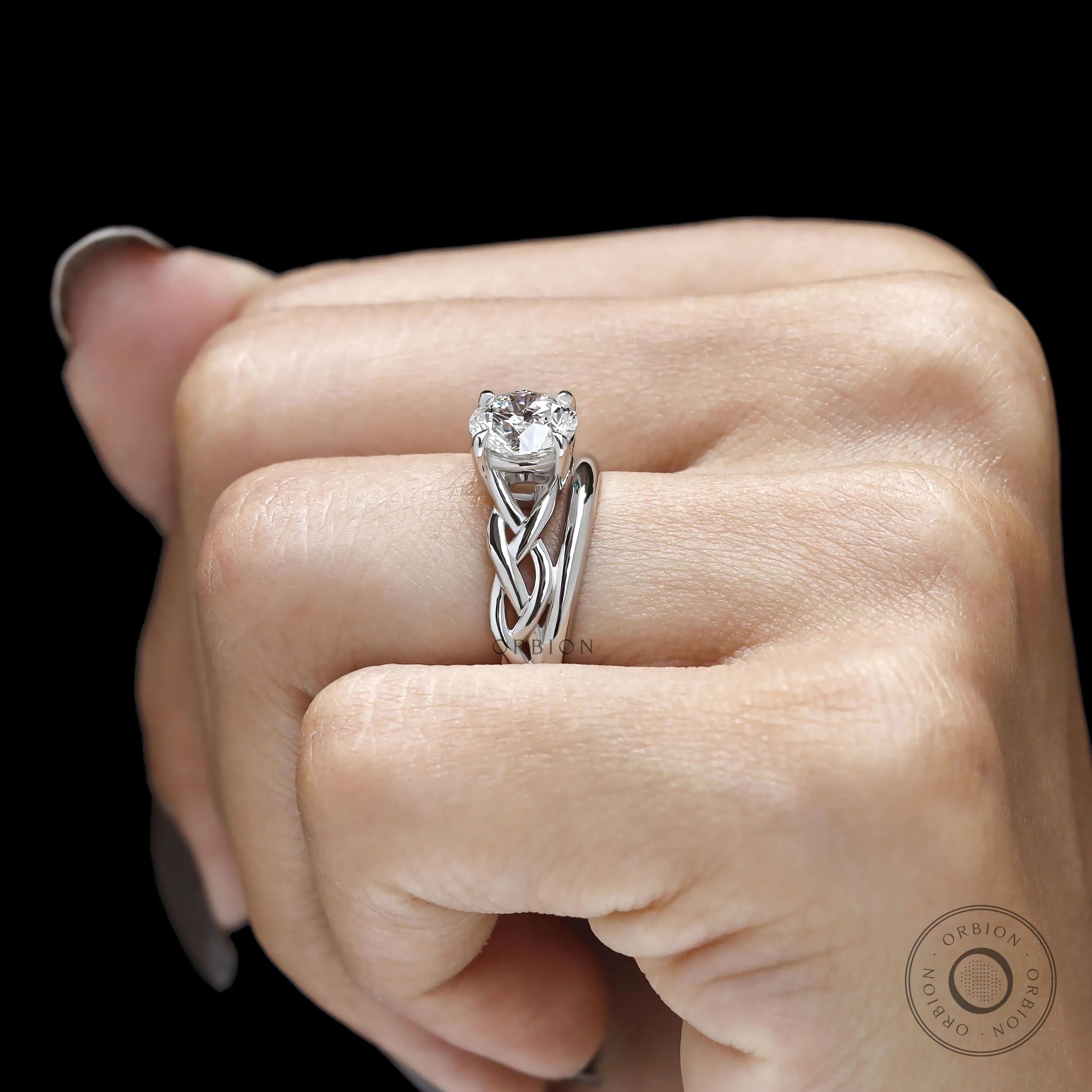Meaningful two birthstone ring with round gemstones, braided band detail and custom engagement ring style