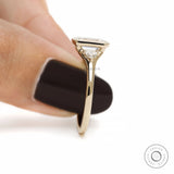 14k yellow gold emerald cut promise ring with three stone bezel design and minimalist bridal style