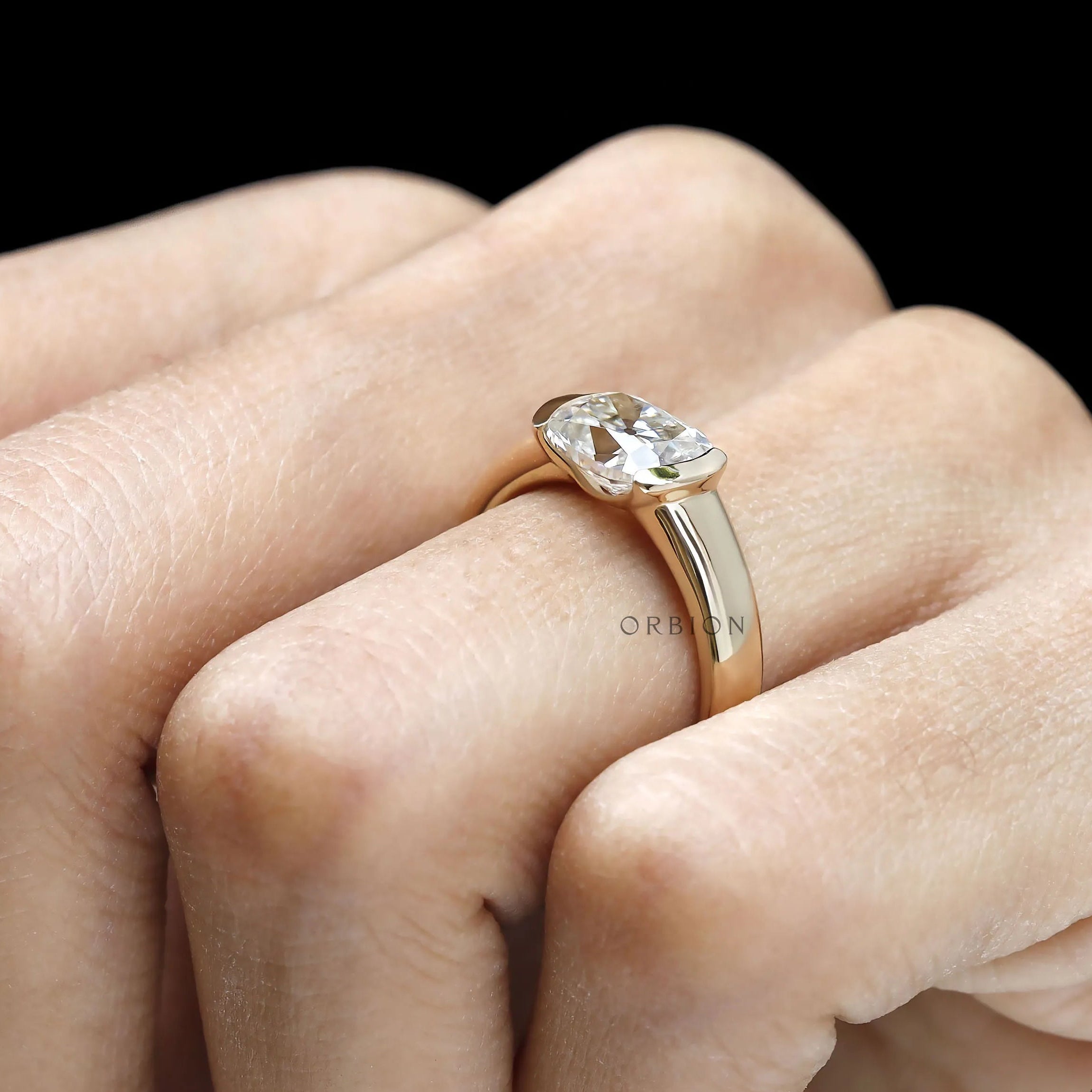 Elegant elongated cushion moissanite ring with wide yellow gold band