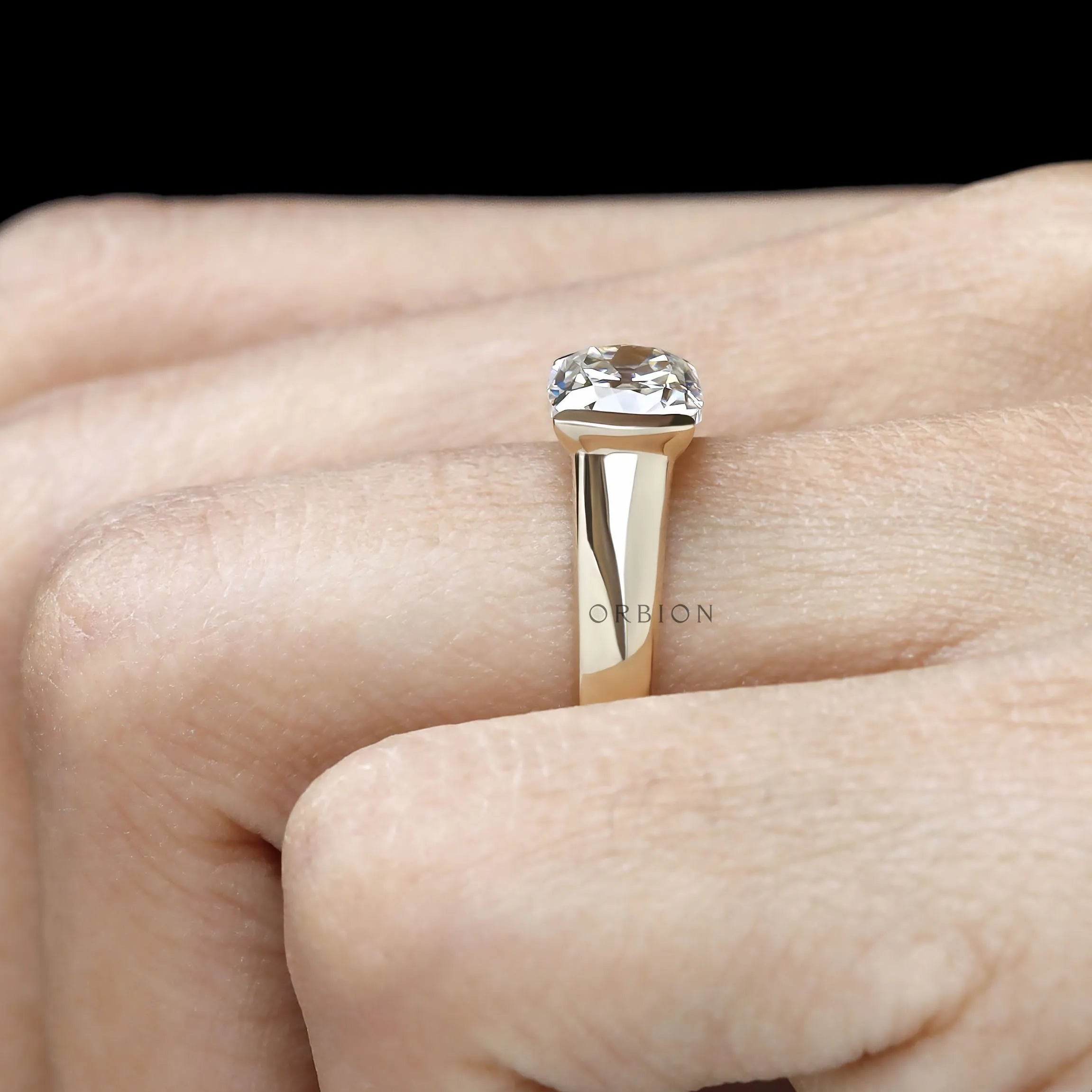 East west half bezel moissanite solitaire ring in solid 14k gold