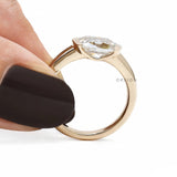 Contemporary half bezel engagement ring with east west moissanite