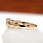 East west moissanite engagement ring with half bezel setting