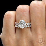 Straight on-hand view of oval lab diamond ring set with double shared prong bands in yellow gold