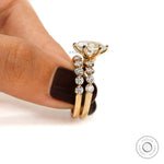 Side macro view of oval lab diamond ring set highlighting prong setting and diamond band alignment
