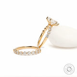 Styled display of oval lab diamond ring with band placed on decorative stone