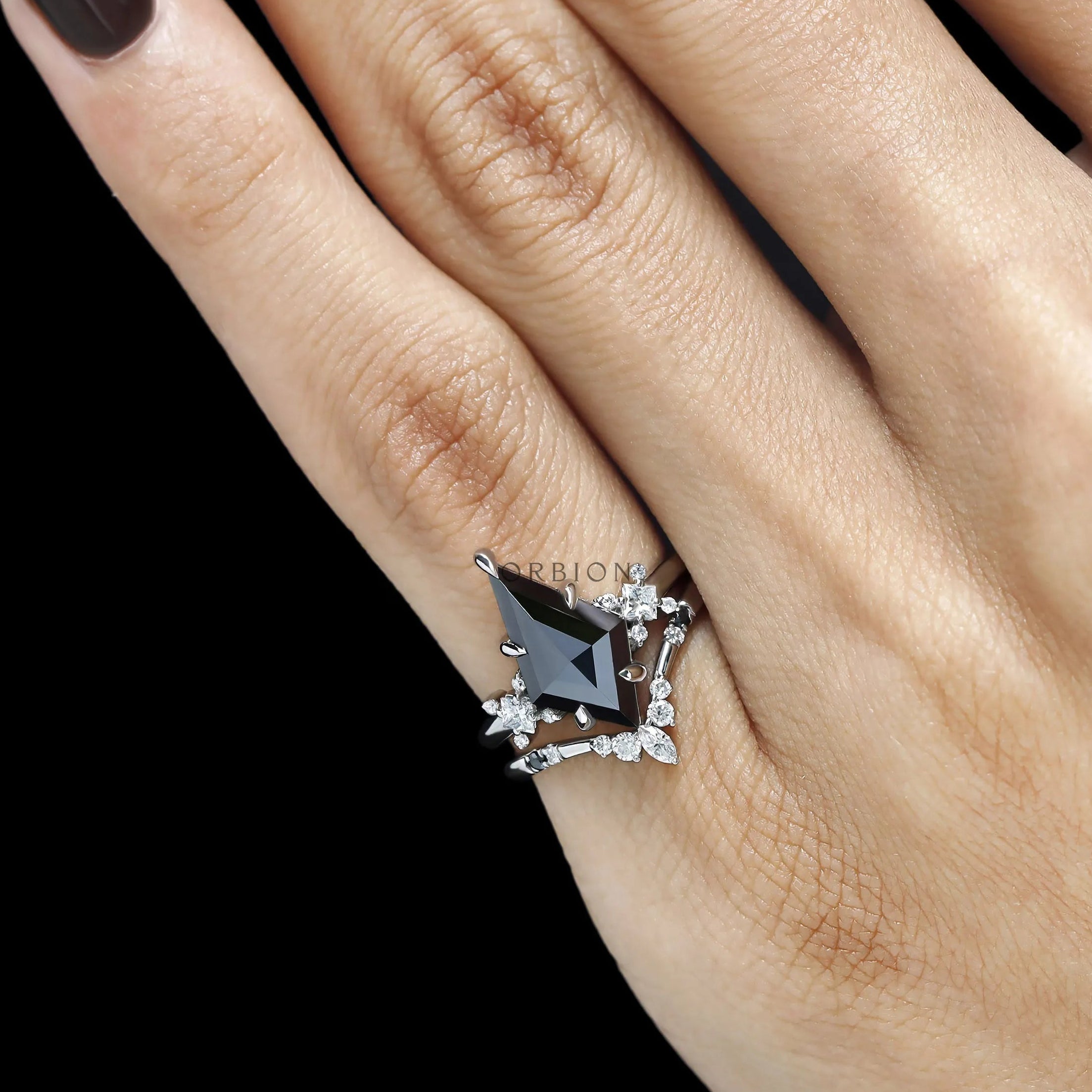 Fine jewelry gothic ring set featuring black moissanite kite cut center stone with nesting wedding band