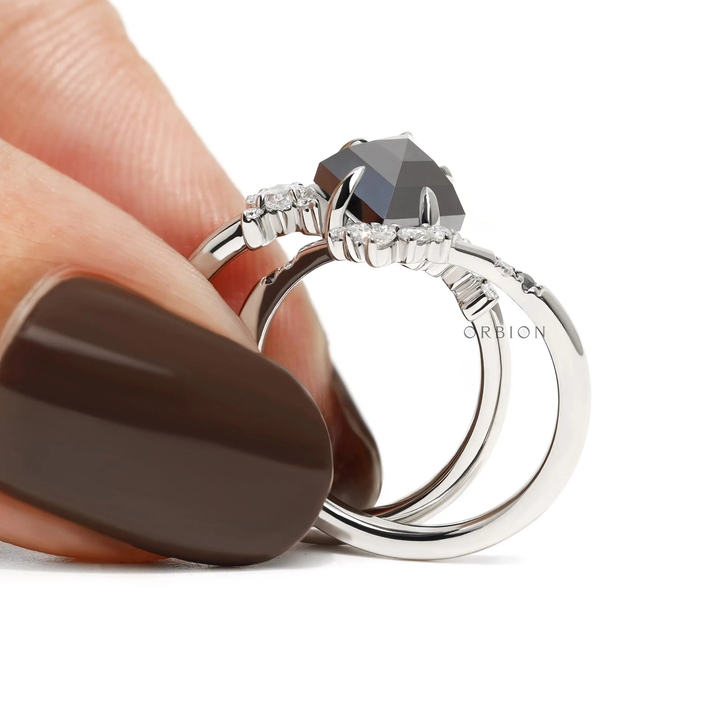 Alternative engagement ring set with kite shaped black moissanite gemstone and platinum chevron band