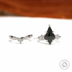 Platinum 950 black moissanite engagement ring set with unique kite cut center stone and matching chevron band