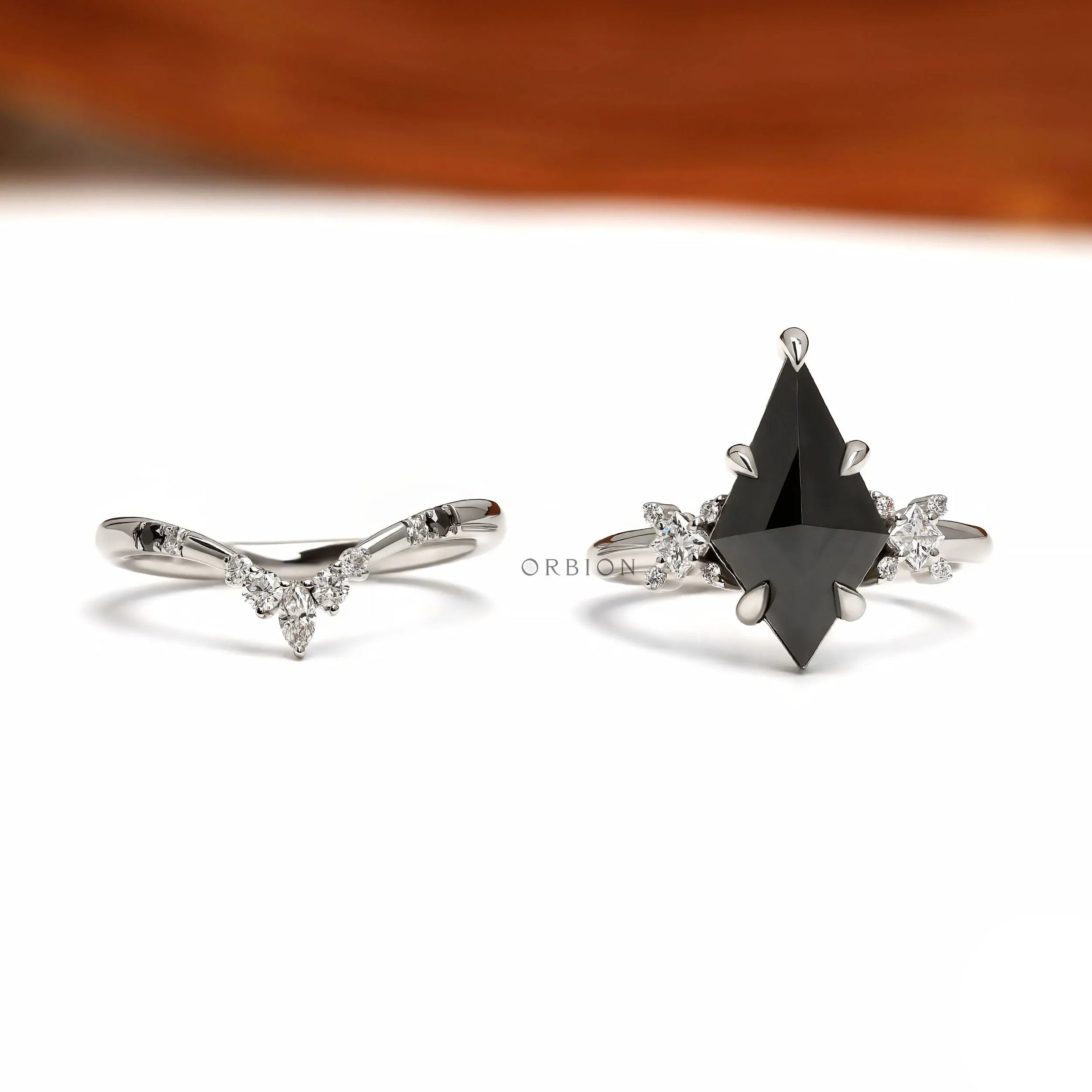 Platinum 950 black moissanite engagement ring set with unique kite cut center stone and matching chevron band