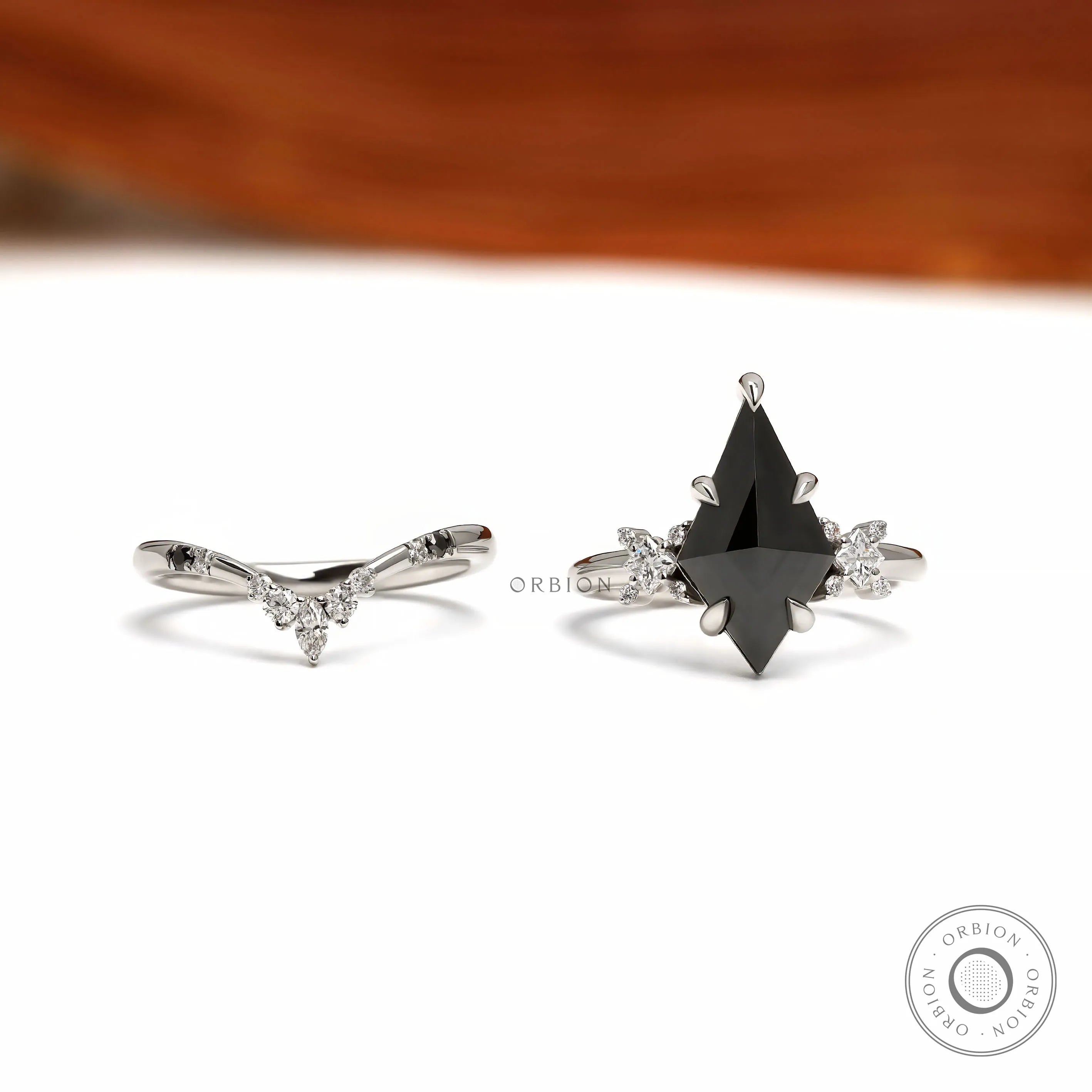 Platinum 950 black moissanite engagement ring set with unique kite cut center stone and matching chevron band