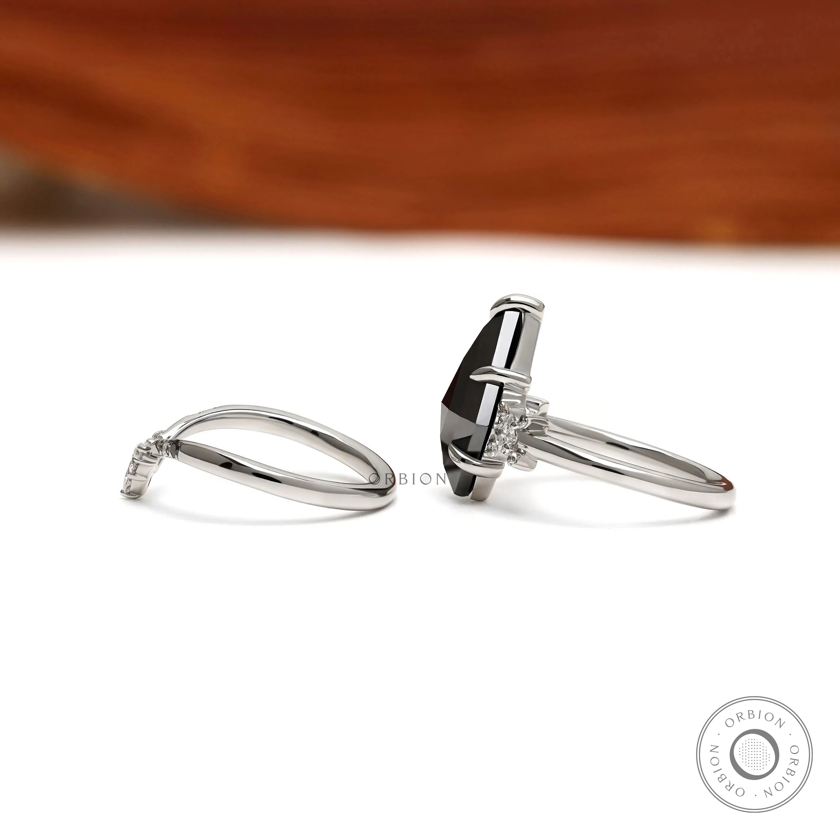 Unique kite cut black moissanite engagement ring with platinum setting and modern chevron stacking band