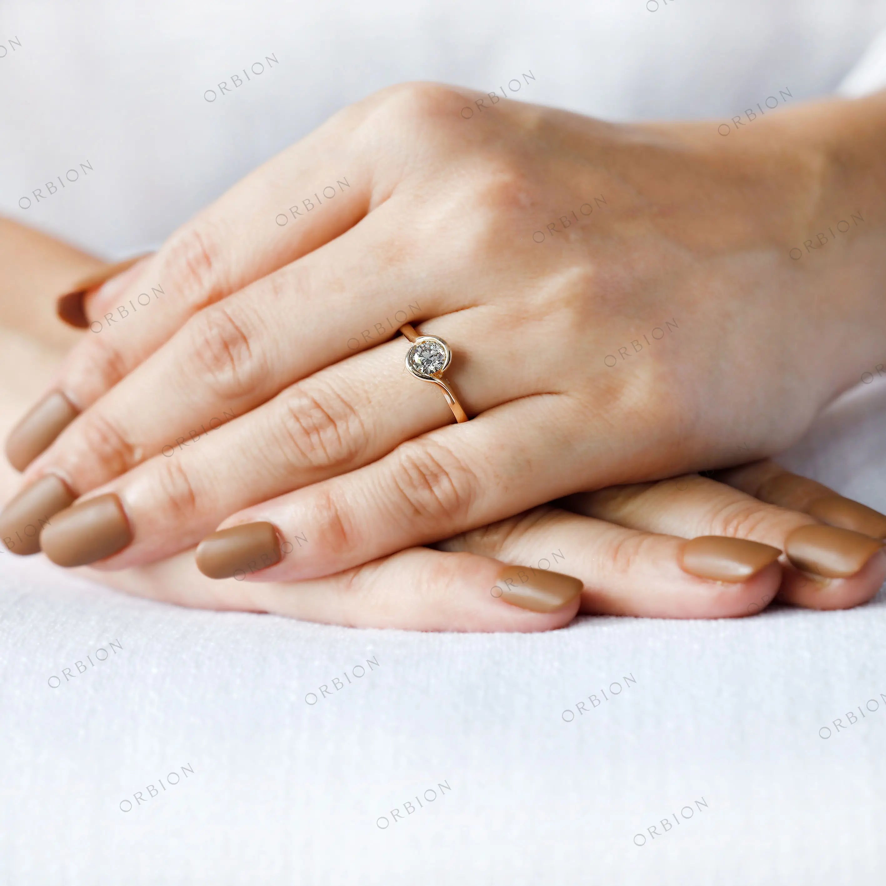 Modern solitaire diamond ring worn on hand