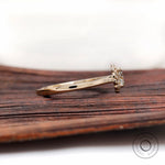 Side profile showing cathedral shoulders in yellow gold ring