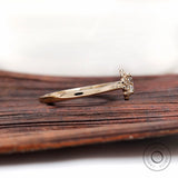 Side profile showing cathedral shoulders in yellow gold ring