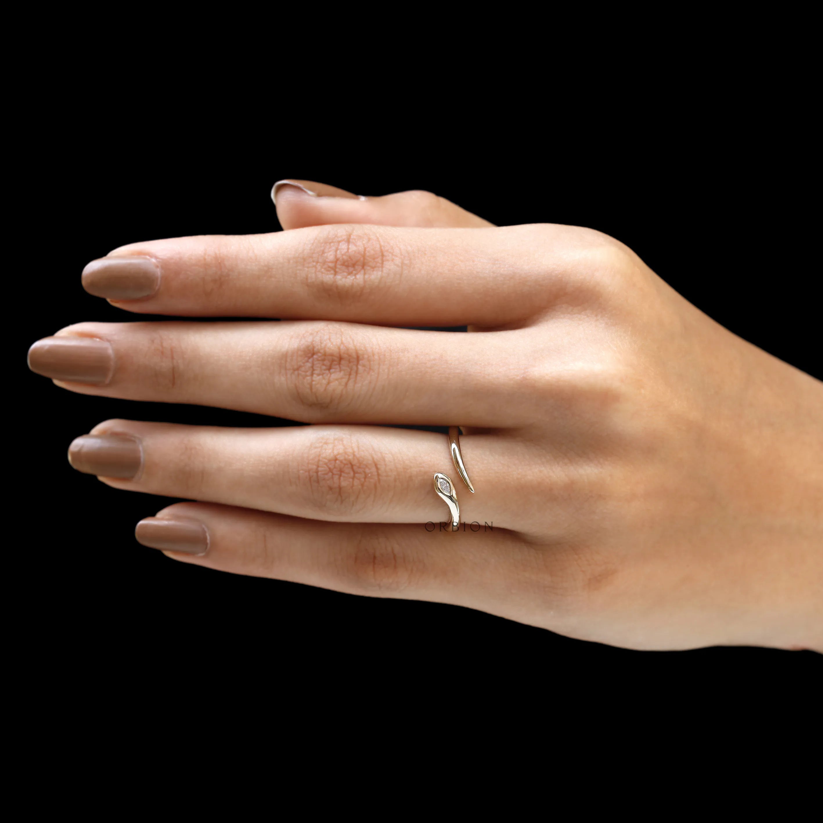 Contemporary 14k gold snake ring featuring a marquise lab diamond