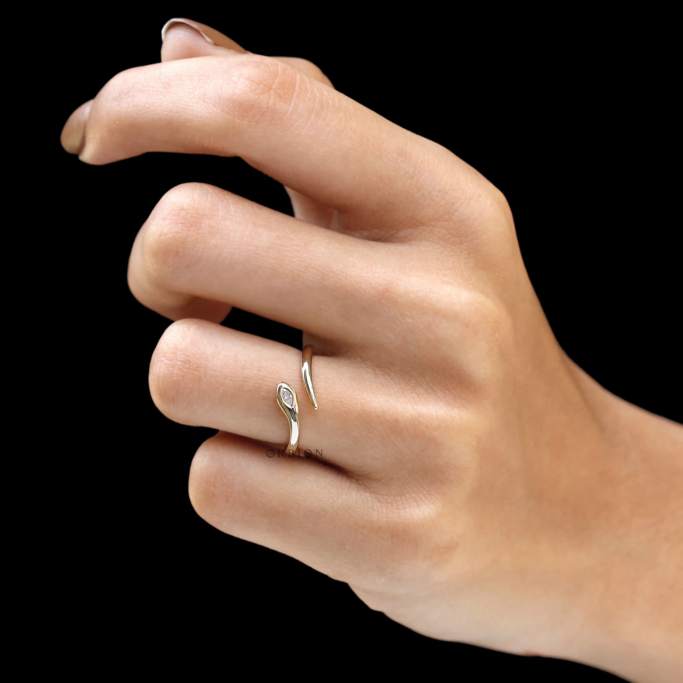 Fine jewelry snake wrap ring with flush set marquise diamond