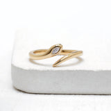Minimalist snake lab diamond ring in 14k yellow gold with flush set marquise diamond