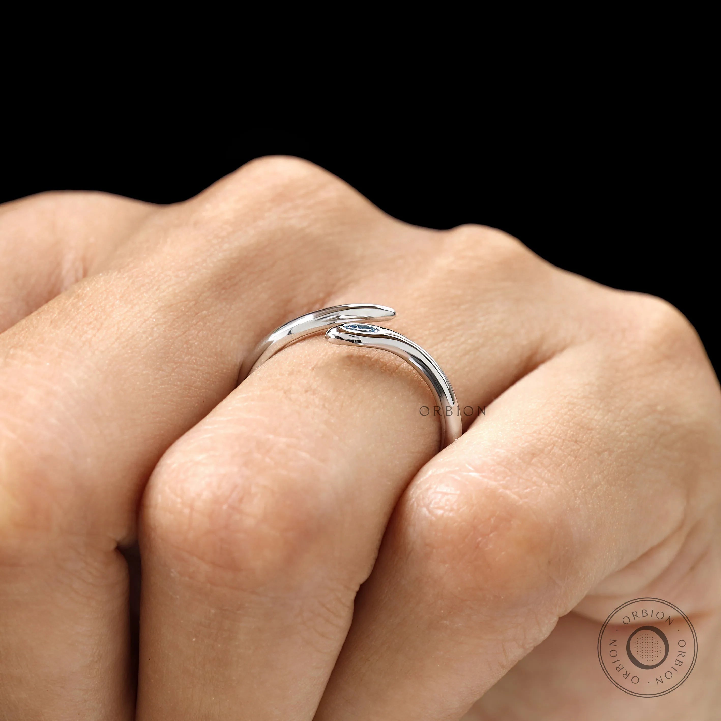 Stackable white gold snake ring with flush set marquise blue diamond