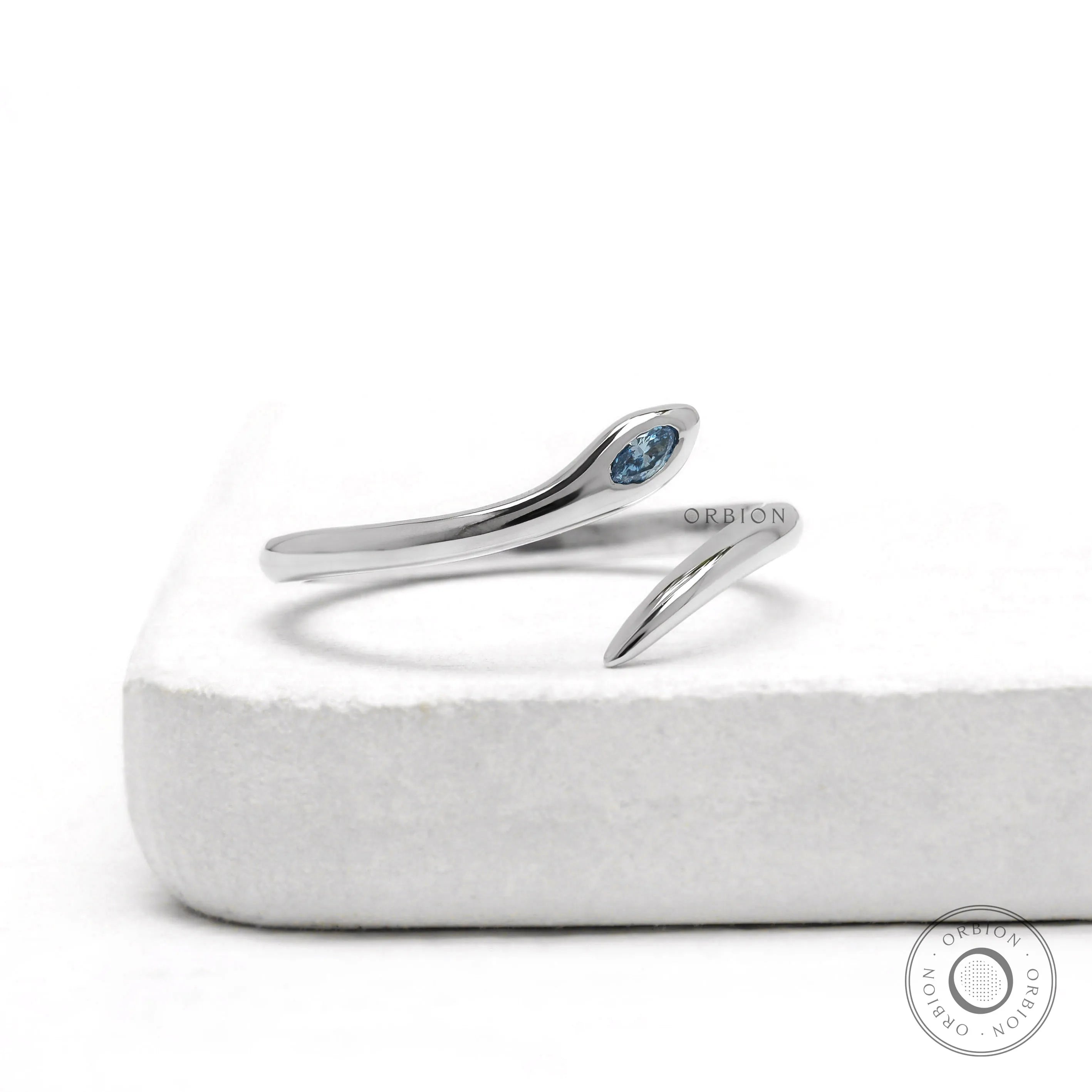Minimalist snake ring in 14k white gold with marquise blue diamond