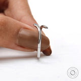 Modern snake inspired white gold ring with blue diamond accent
