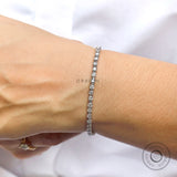Round lab diamond tennis bracelet in 10K white gold on hand