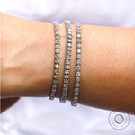 Elegant tennis bracelet worn on hand with natural lighting