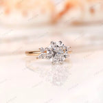 Round brilliant lab grown diamond cluster ring with marquise and round accents straight-on view