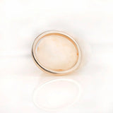 Minimal plain gold band photographed from top view on white surface
