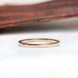 Thin classic gold wedding band side profile with smooth polished finish