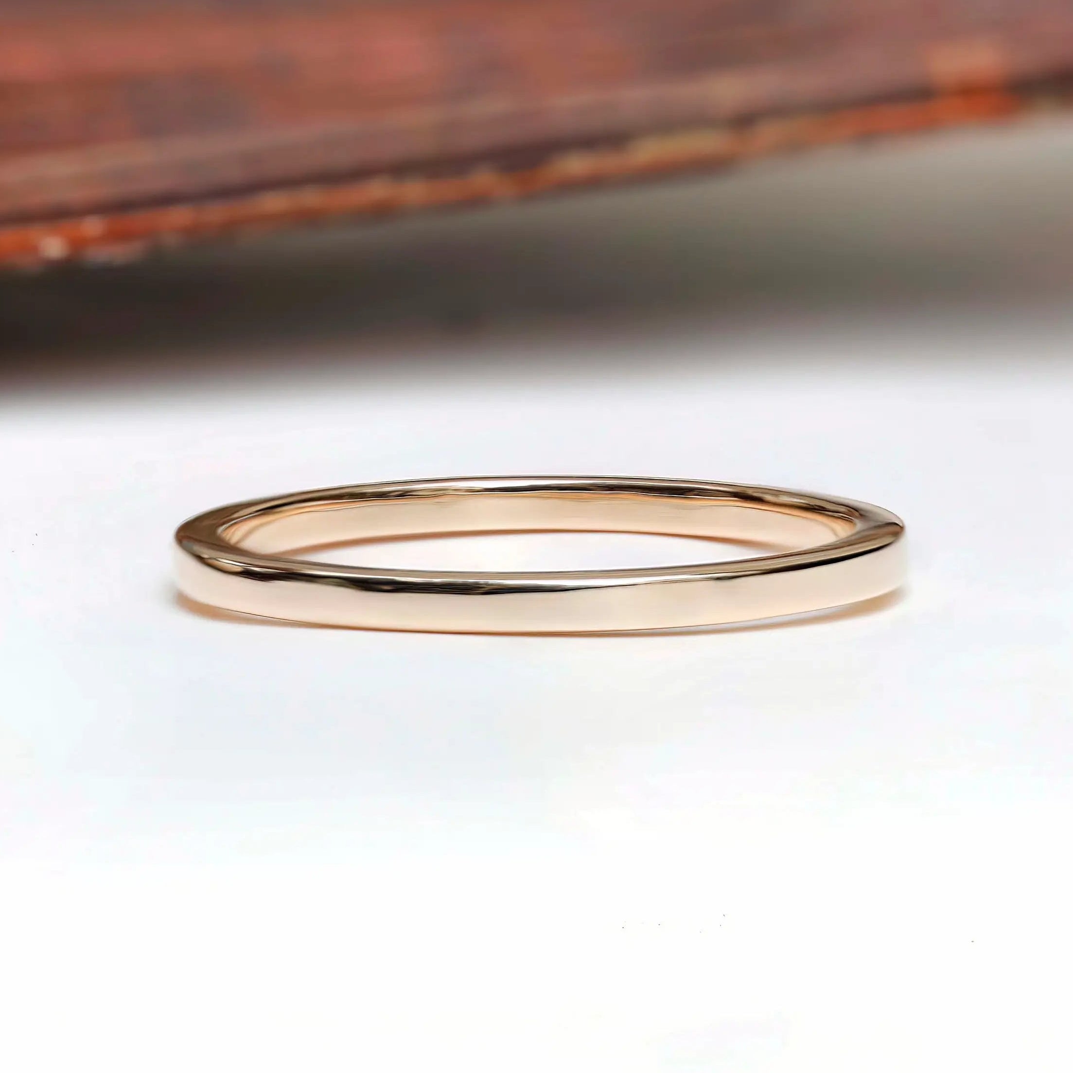 Thin classic gold wedding band side profile with smooth polished finish