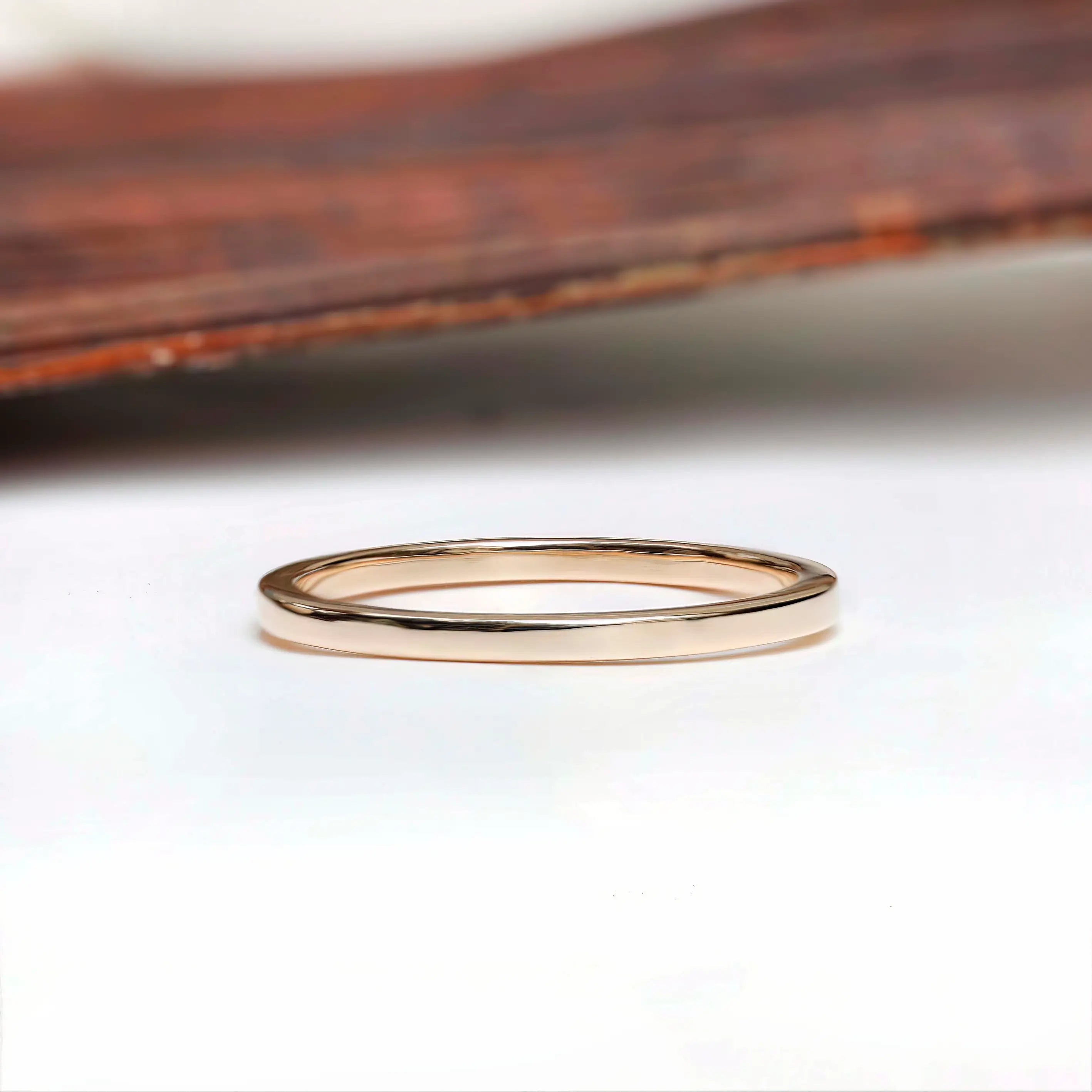 Thin classic gold wedding band side profile with smooth polished finish