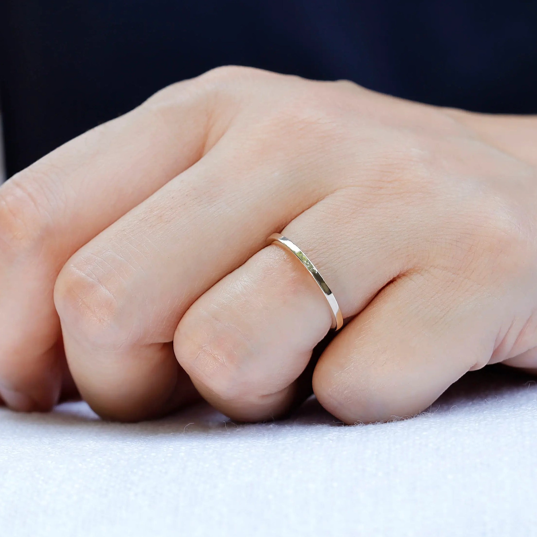 Slim plain gold band worn on hand for everyday minimalist look
