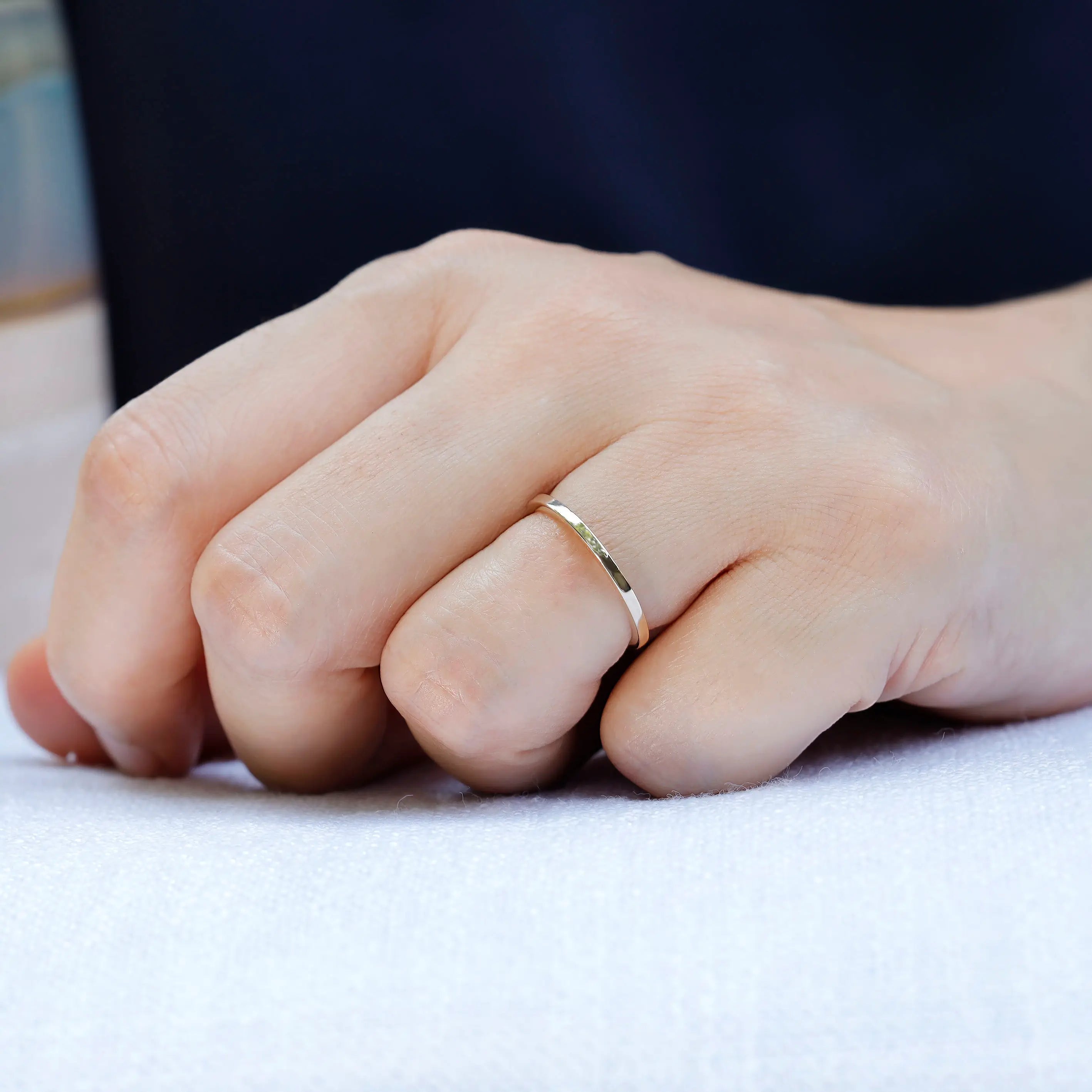 Slim plain gold band worn on hand for everyday minimalist look