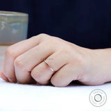 Slim gold band ring shown worn on finger for everyday minimalist styling